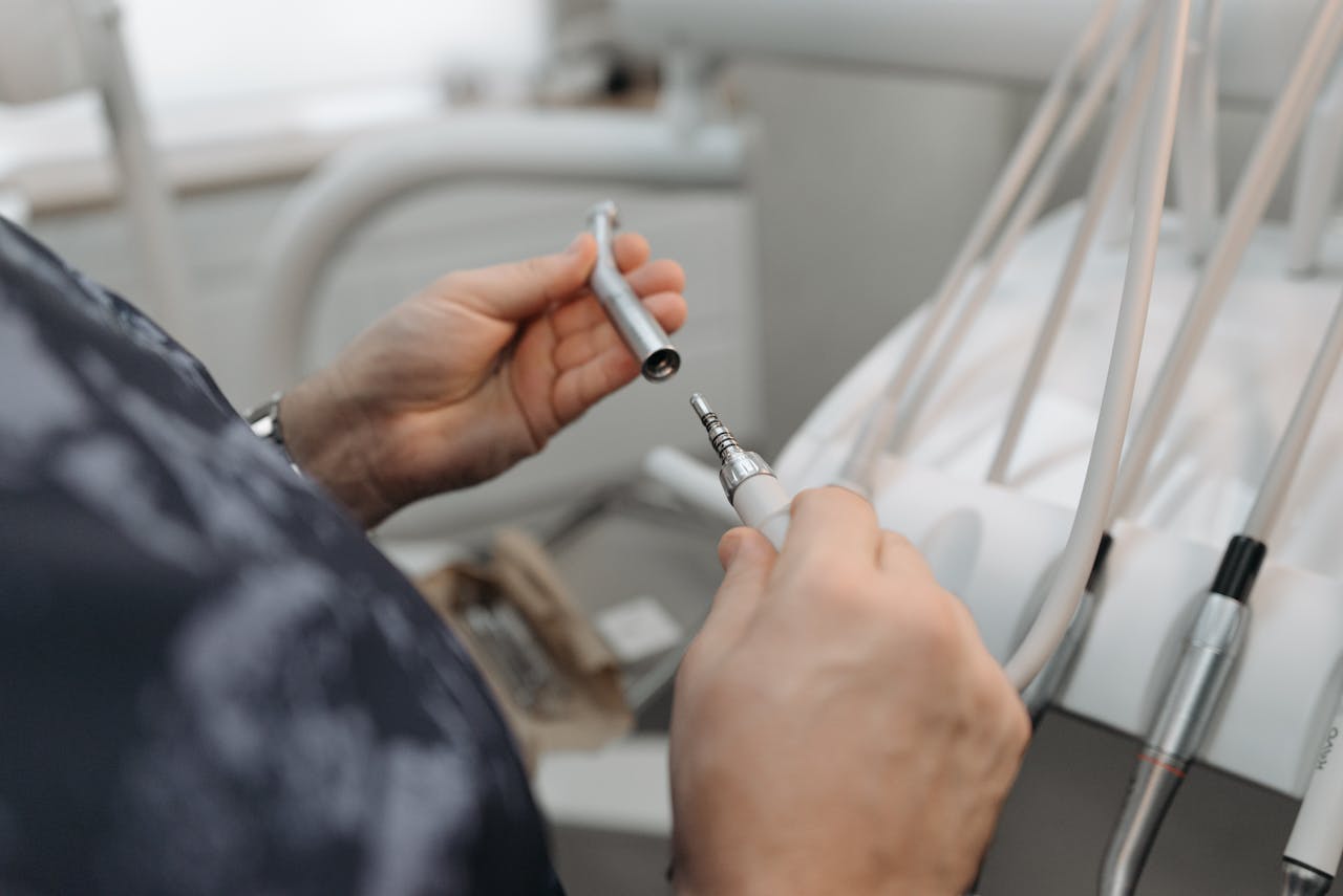 A Person Holding a Dental Tool